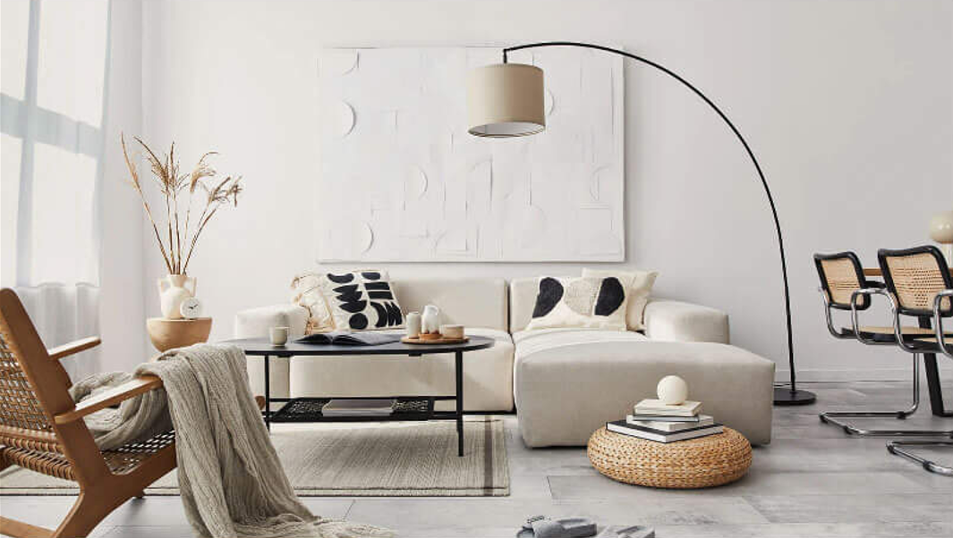 Bright Scandinavian living room with white sofa, armchair and neutral decor
